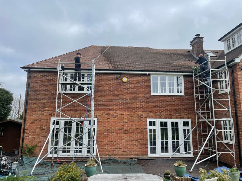 Roof cleaning carried out safely from scaffold towers by The Roof Moss Cleaners in Horley
